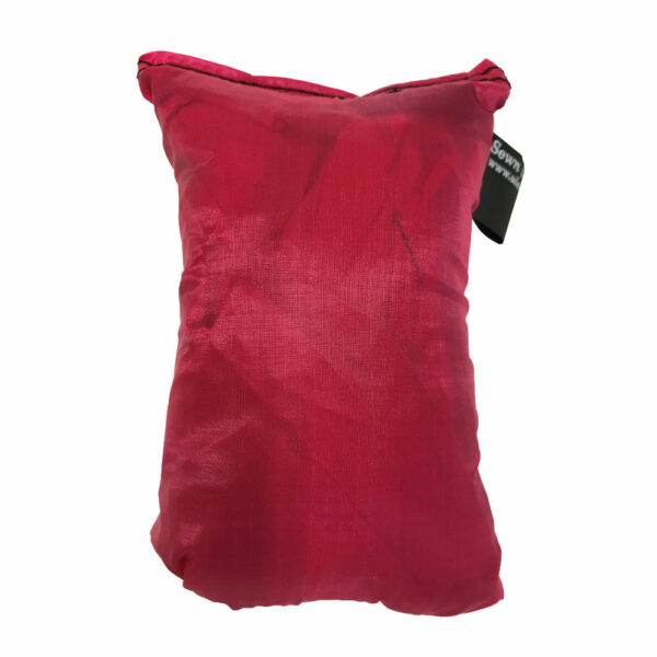 An ultralight ULA Pack Cover in it's built-in stuff sack in the color Red.