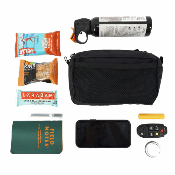The ULA Spare Tire Waist Pack / Fanny Pack is suprisingly roomy for it's size. It fits: three trail bars, a bear spray, field notes book and mini pen, phone, key fob, and lip balm!