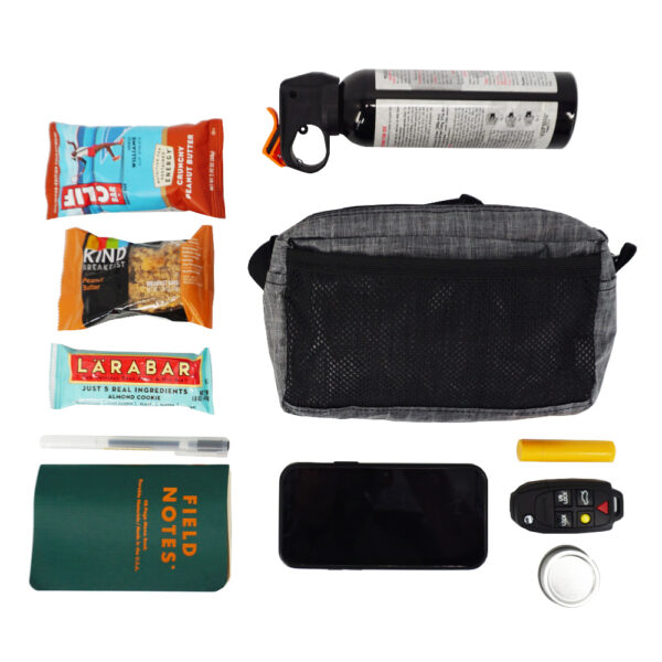 The ULA Spare Tire Waist Pack / Fanny Pack is suprisingly roomy for it's size. It fits: three trail bars, a bear spray, field notes book and mini pen, phone, key fob, and lip balm!