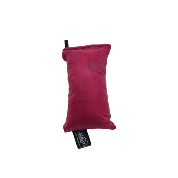 An ultralight ULA Rain Kilt in it's built-in stuff sack in the color raspberry.