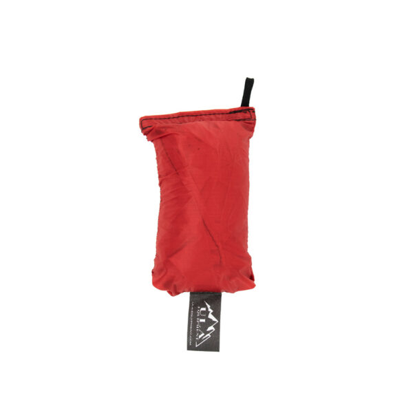 An ultralight ULA Rain Kilt in it's built-in stuff sack in the color Red.