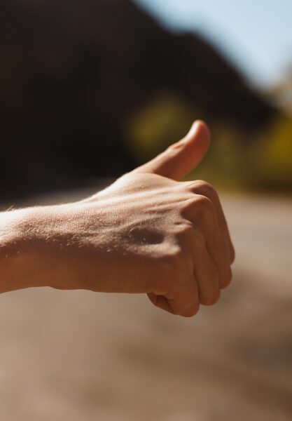 A fist with its thumb up is shown.