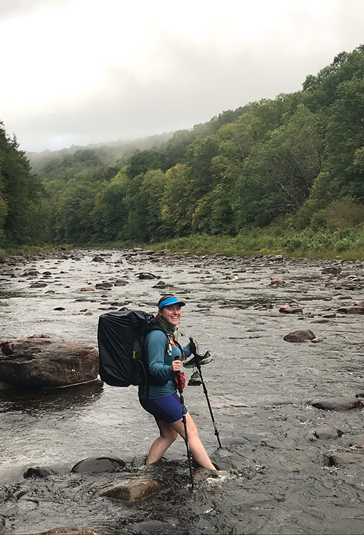 Backpacker puts a Bear Vault Bear Canister into a ULA CDT Backpack