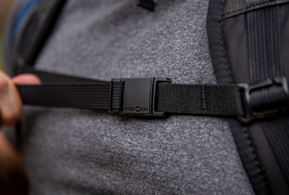 A backpacker closes their Fidlock Magnetic Sternum Strap