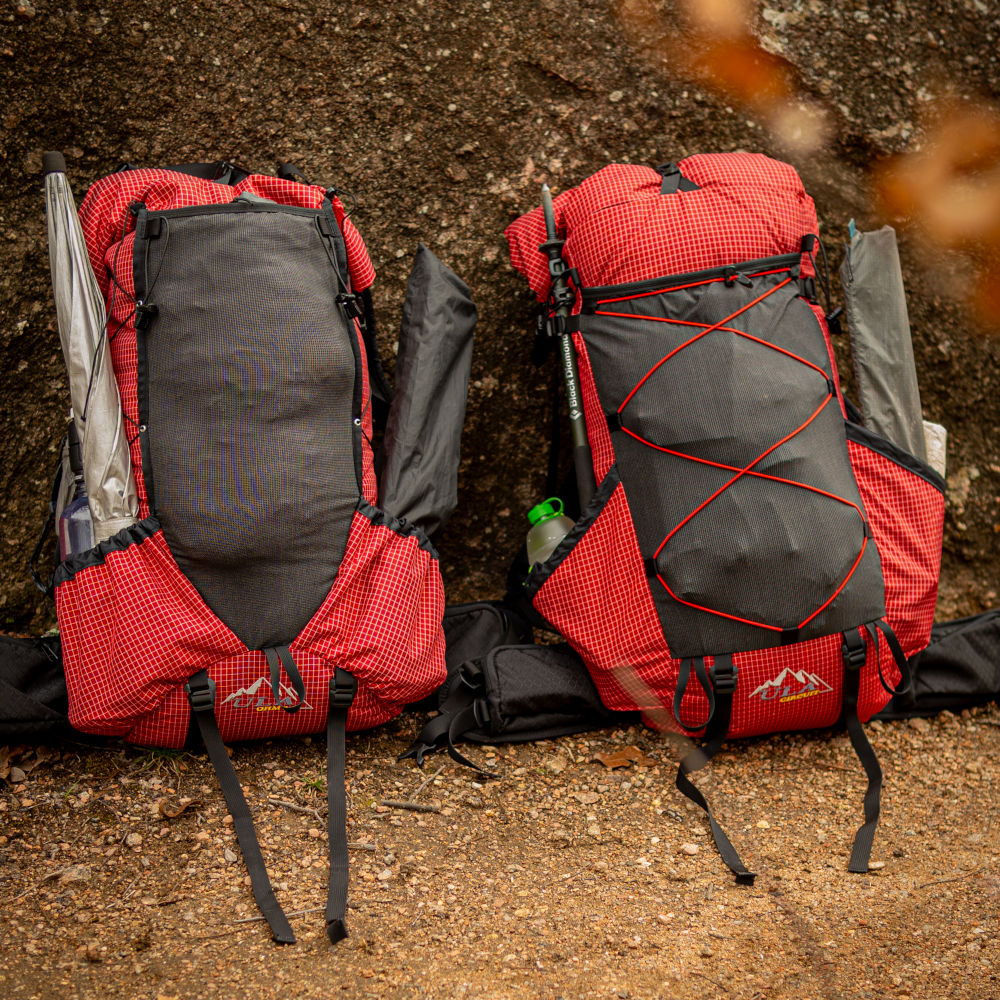 Two Red Robic 2024 Ohms sitting next to a rock on a trail