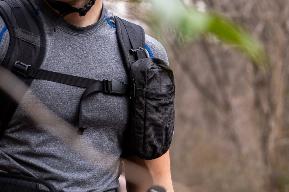 A backpacker closes their Fidlock Magnetic Sternum Strap