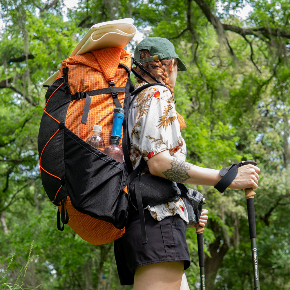 Orange Catalyst on female backpacker