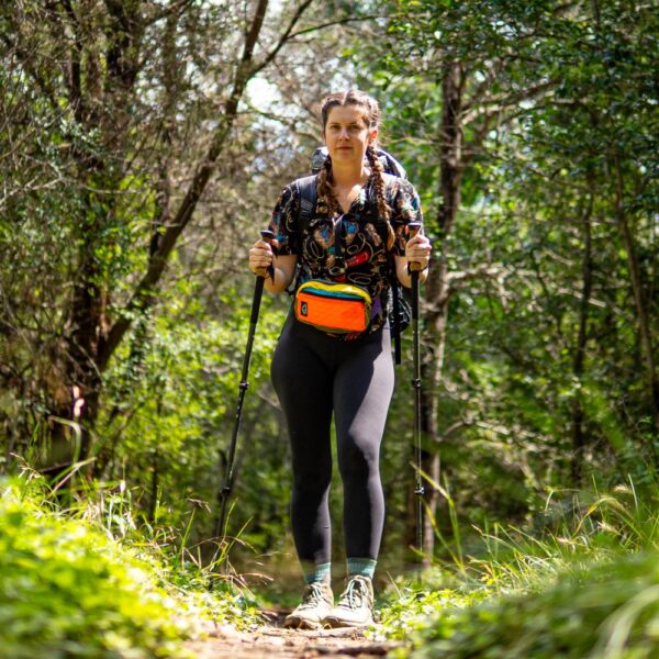 Hiker wears colorful Entropy Spare Tire Waist Pack