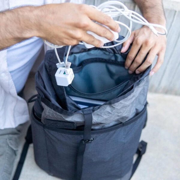 Urban explorer adds charging cord to small zippered Packrat pocket for save keeping