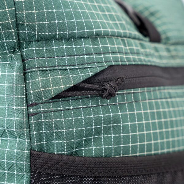 A close up view of the zipper garage on the eternal front pocket of the ULA Node backpack.