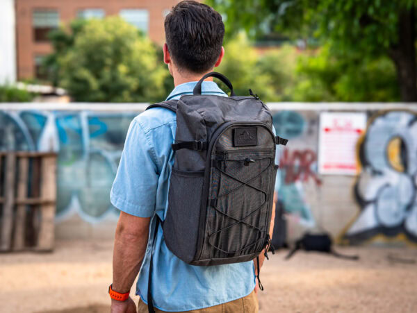 An urban explorer wears the ULA Dragonfly backpack while walking downtown.