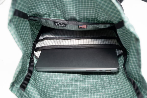 Interior sleeve of the ULA Robic Node daypack, showing the padded, static laptop sleeve, main sleeve, mesh sleeve, and the main compartment.
