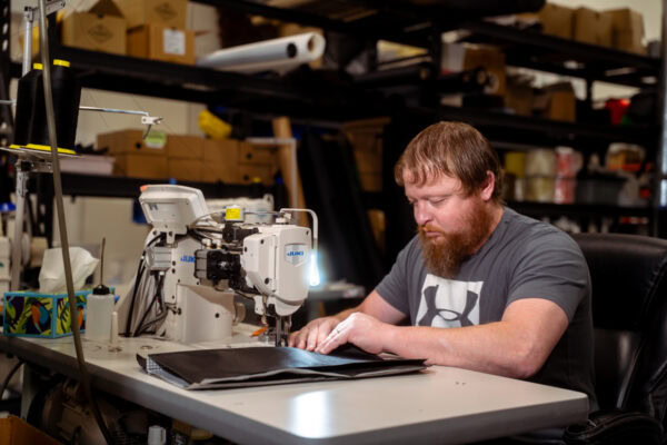 A ULA team member sews together a pack in the ULA factory in Logan, Utah.