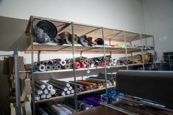 Rolls of technical fabric sit on a shelf in the ULA factory