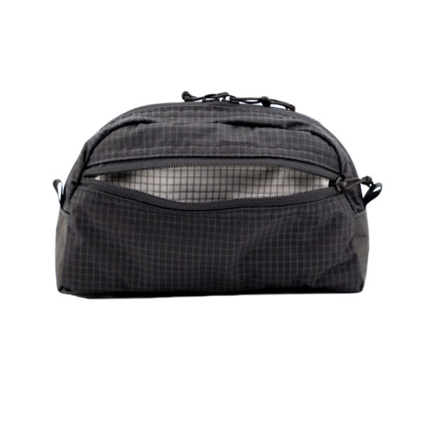 Back view of the ULA toiletry kit with the back exterior pocket open.