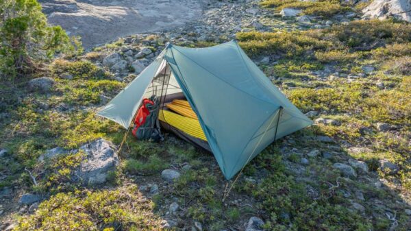 A double walled tent with a backpack