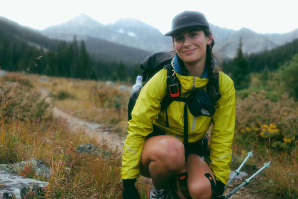 A woman poses on trail