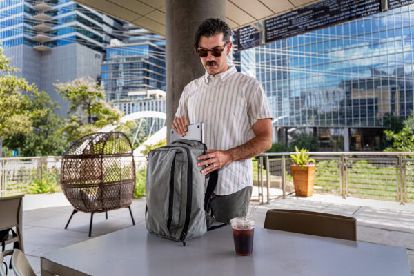 A man poses with a ULA Cicada Backpack