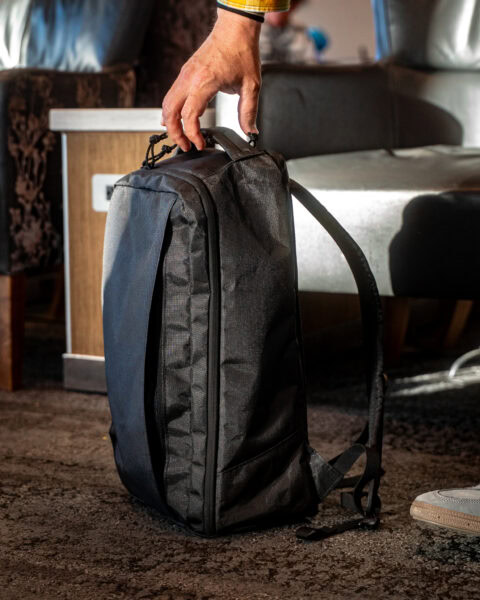 A man picks up a ula cicada backpack