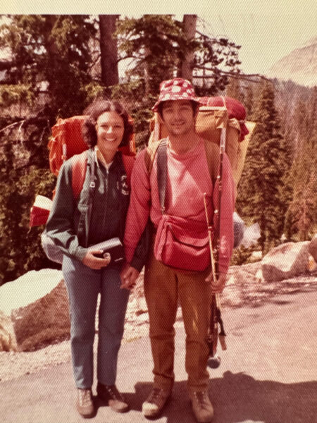 A man and woman pose while on a backpacking trip in 1968