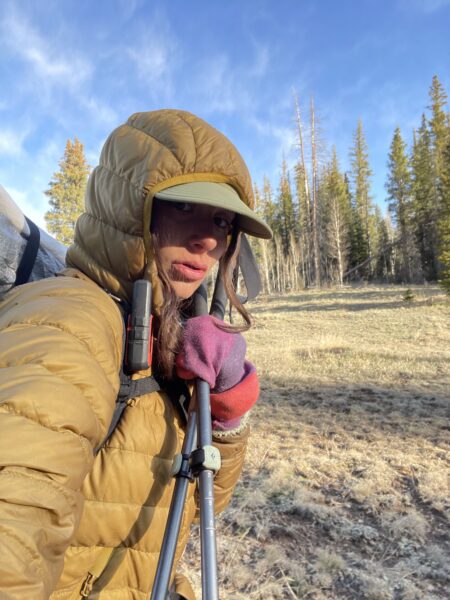 A woman backpacking in cold conditions