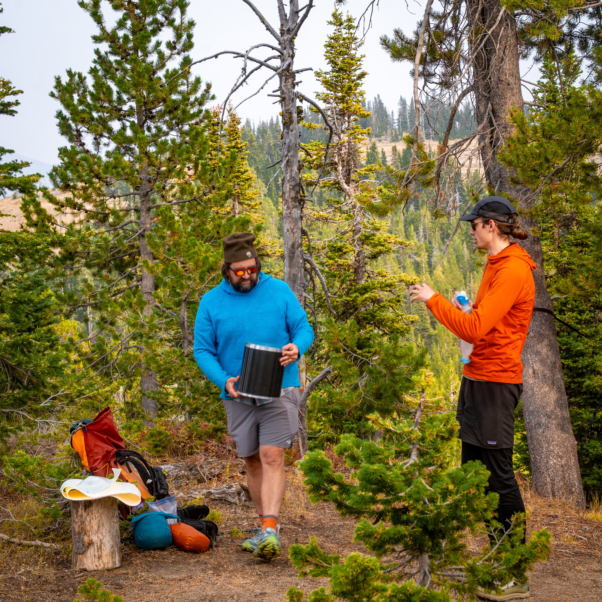 bearicade Two men on a backpacking trip handling a bear canister