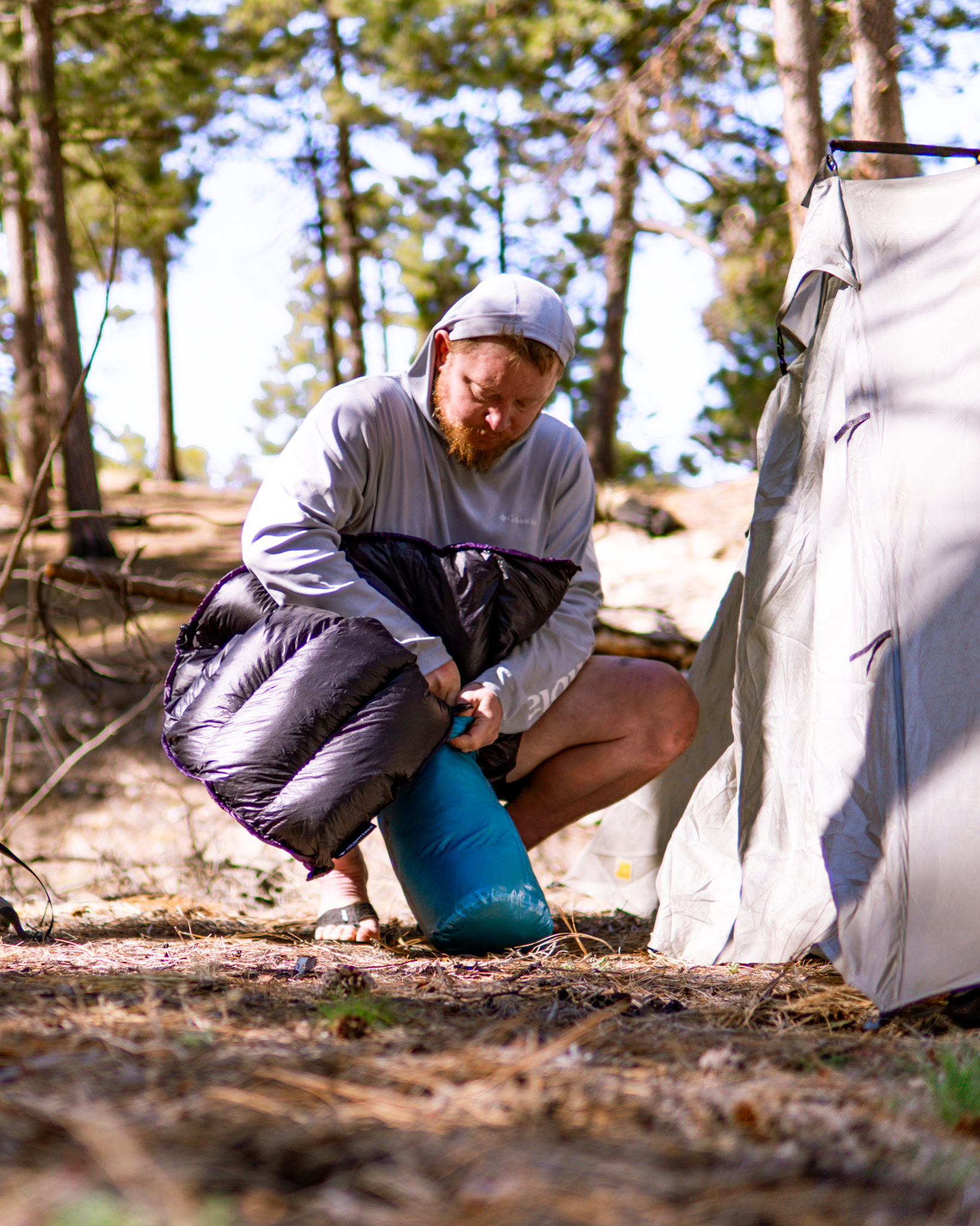 sleeping -1 A man packs his sleeping bag