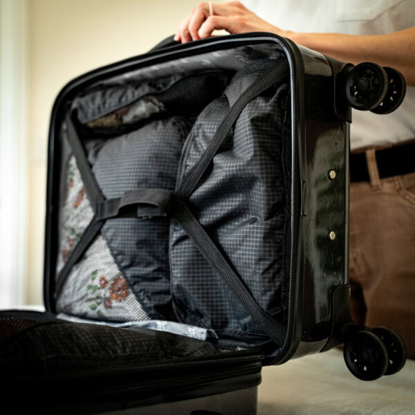 A traveler loads her carryon luggage bag