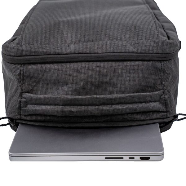Top View of the Cicada with Pockets showing a laptop being inserted into the laptop sleeve