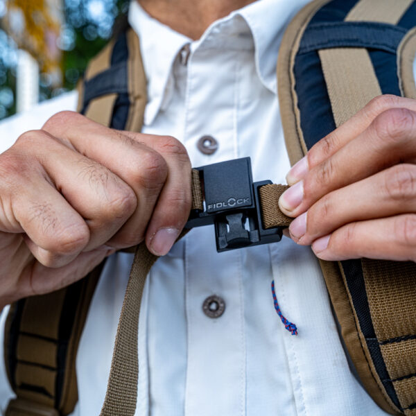 A man clips together the magnetic sternum strap on his Muse Cicada