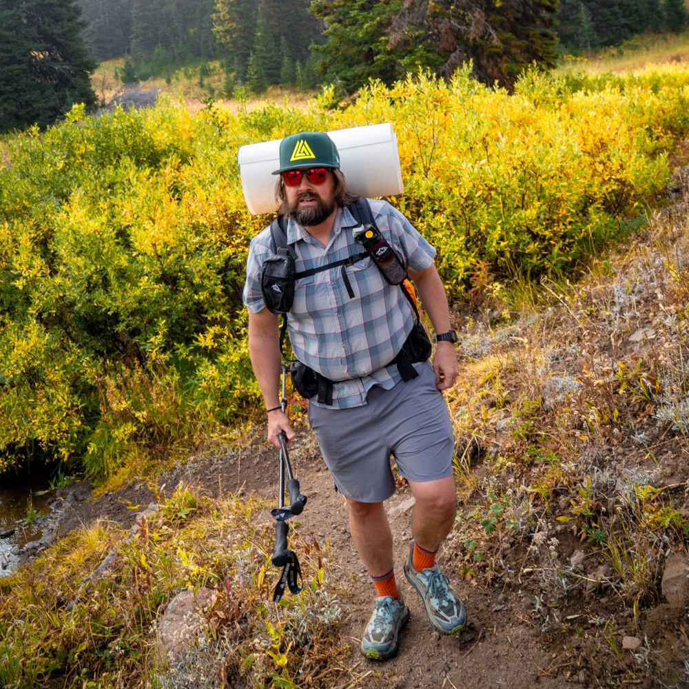 A backpacker wears a NewEra hat on the trail
