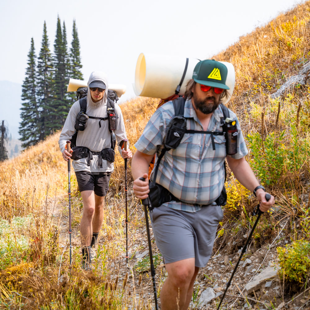 A backpacker wears a NewEra hat on the trail
