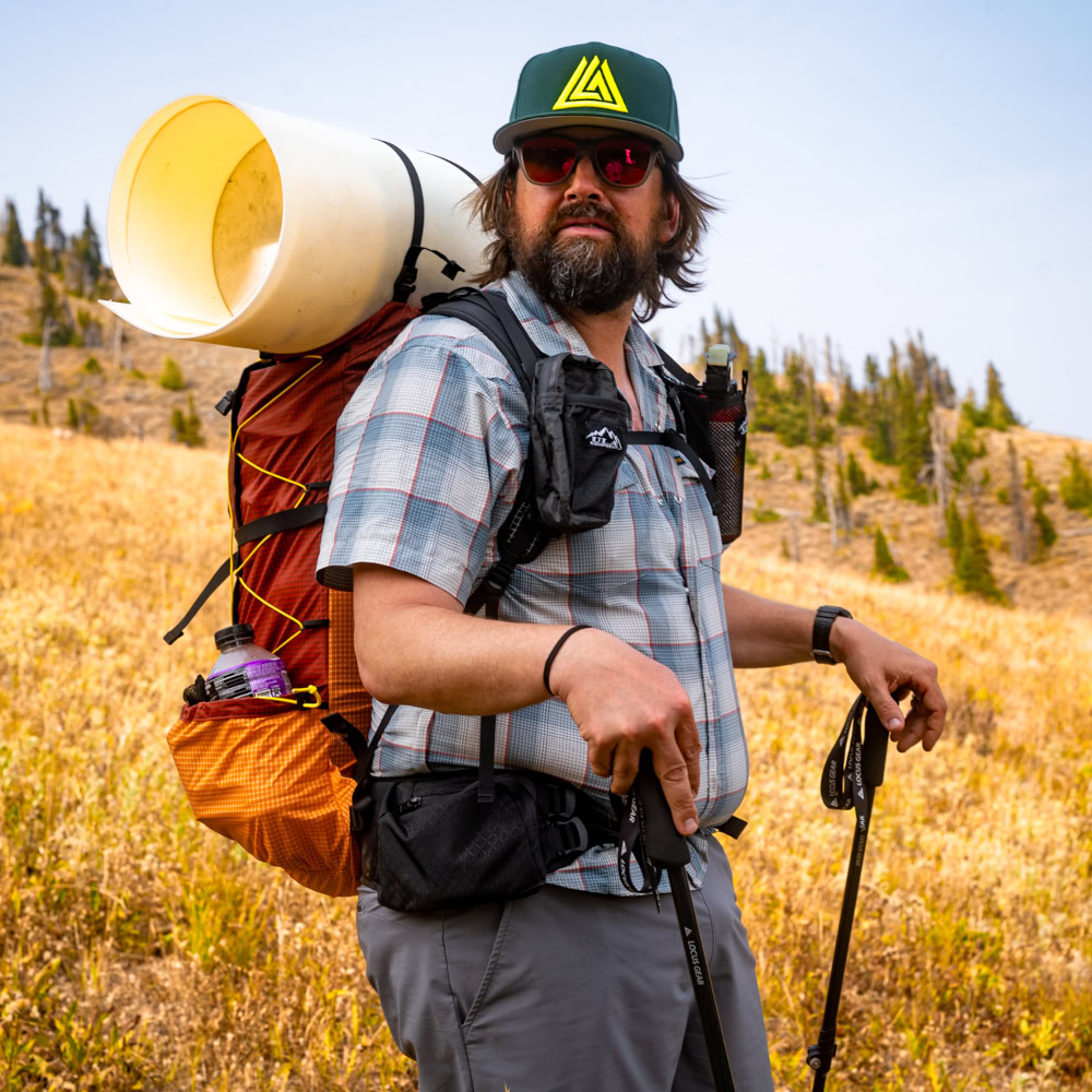A backpacker wears a NewEra hat on the trail