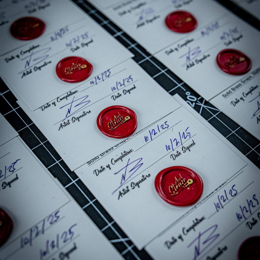 A close up of the ULA Dragonfly Grip-It Authenticity Cerrtificates lined up on a desk