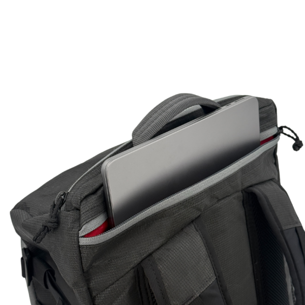 A detail view of the Bespoke 36L Dragonfly 0226 Dia de los Muertos showing a laptop inserted into the exterior back laptop pocket