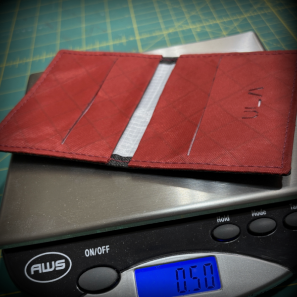 Wasatch wallet open on a scale showing 50 gms