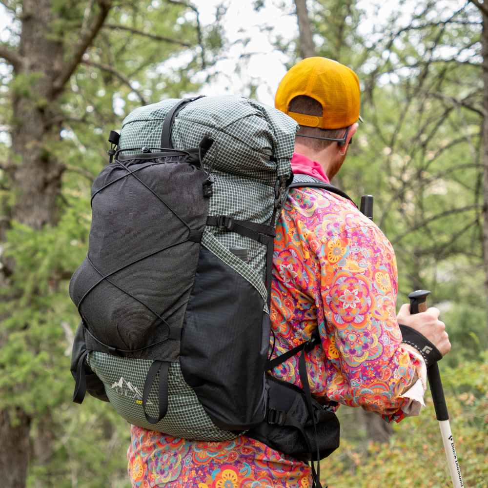 A hiker wears the 2026 UltraGrid CDT on a trail