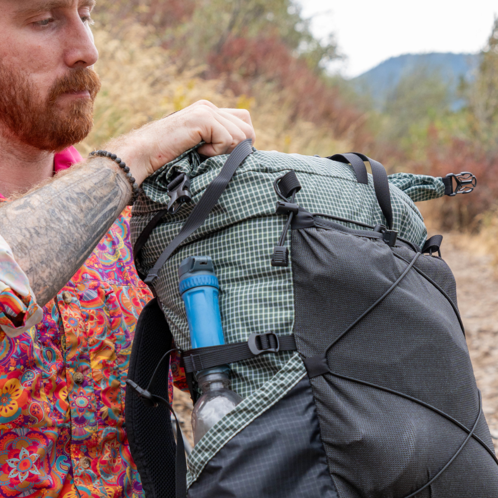 A hiker rolls down the collar of their 2026 UltraGrid CDT