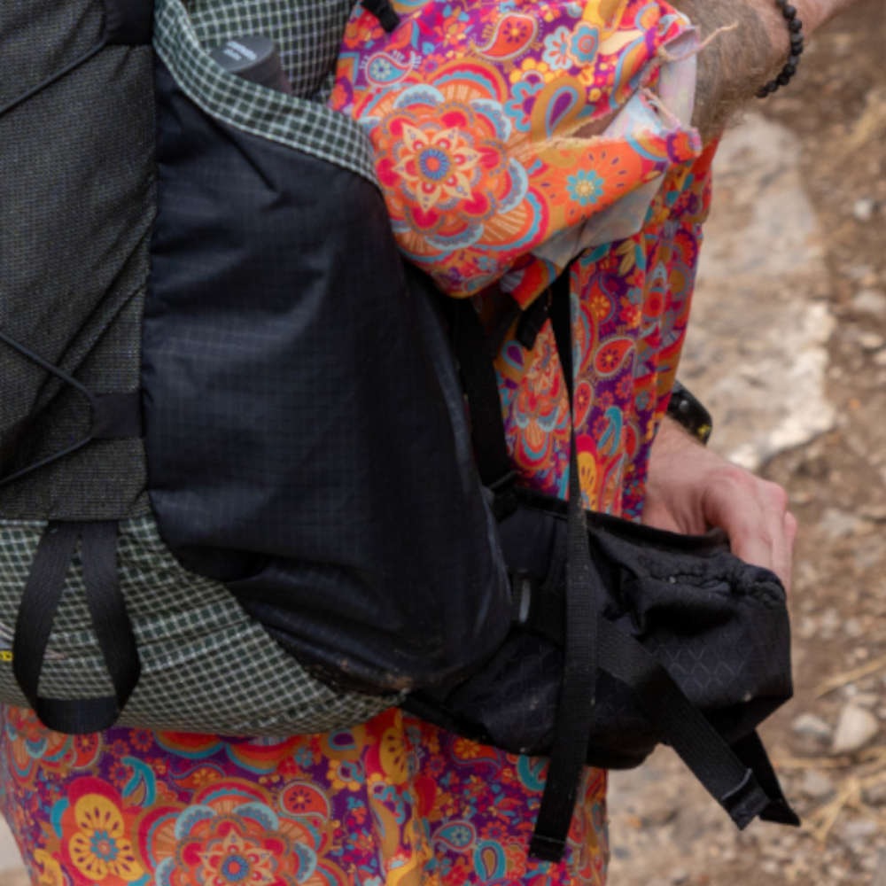 A hiker digs into the hipbelt pocket of their 2026 UltraGrid CDT